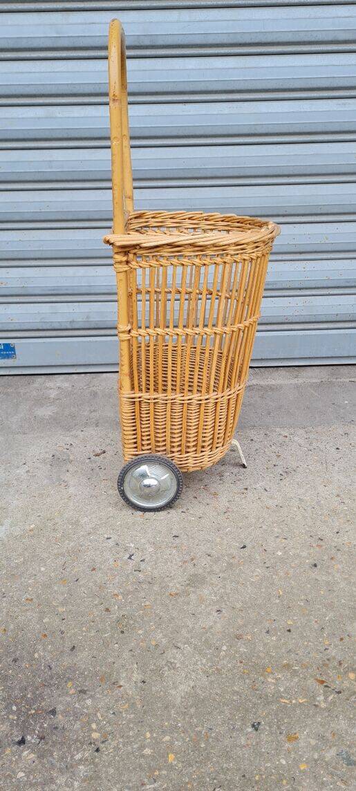 Vintage wicker log basket on vintage wheels