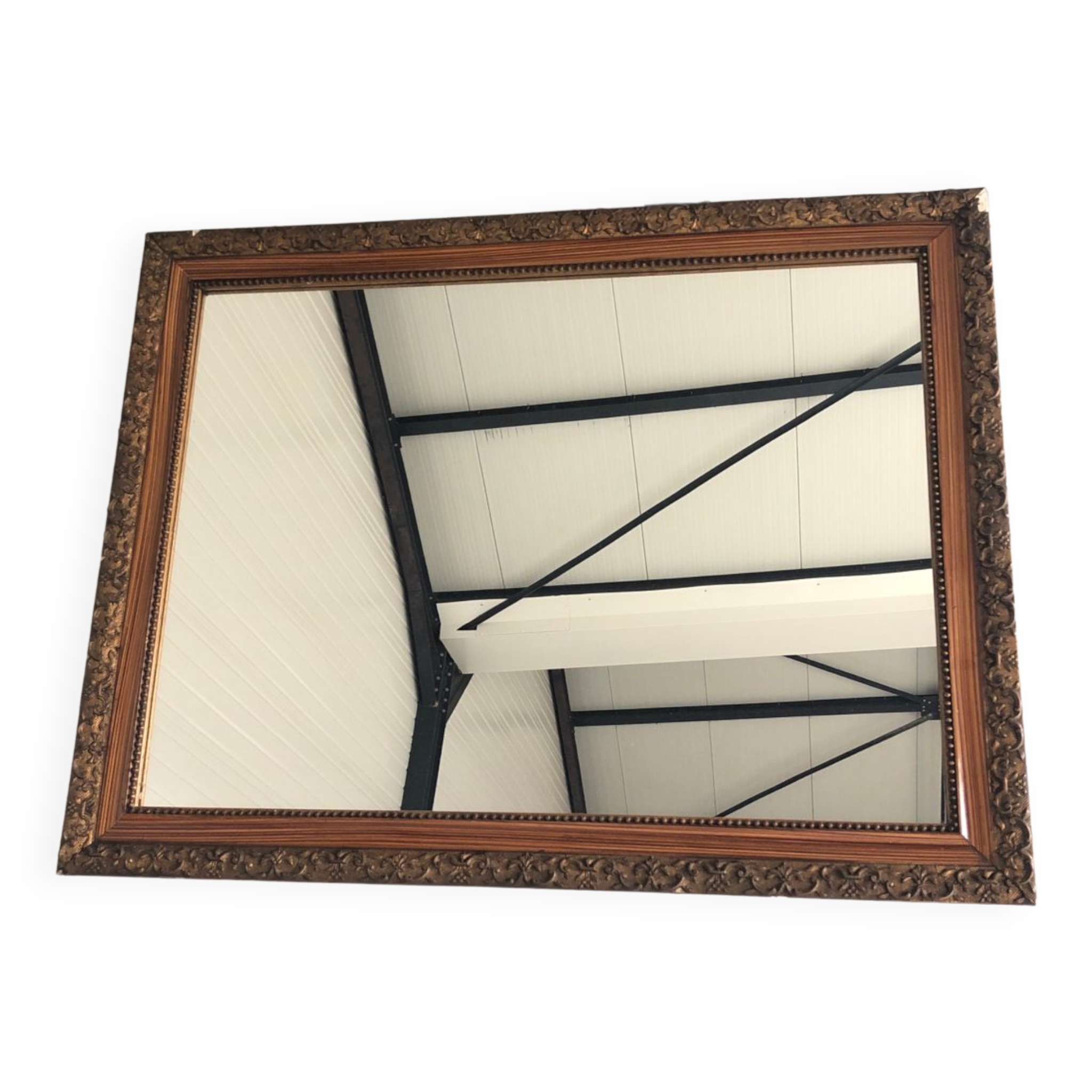 Old mirror with wooden frame and plaster moldings