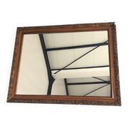 Old mirror with wooden frame and plaster moldings