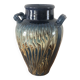 Vase in glazed ceramic decoration drips on blue background