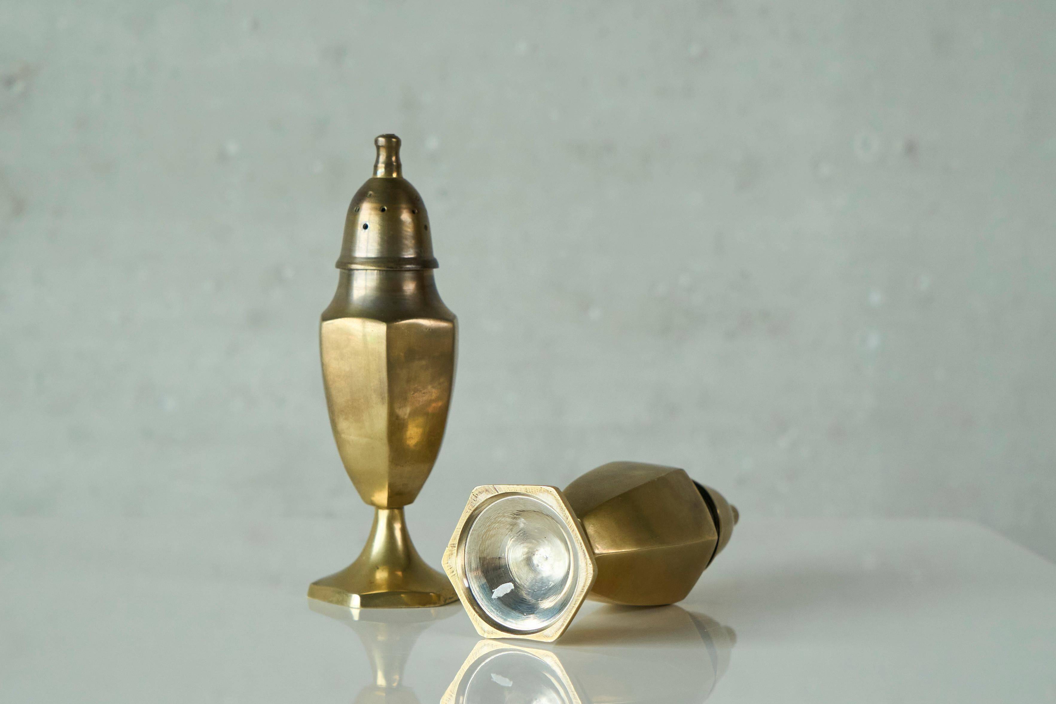Pair of patinated brass salt and pepper shakers, 20th century.