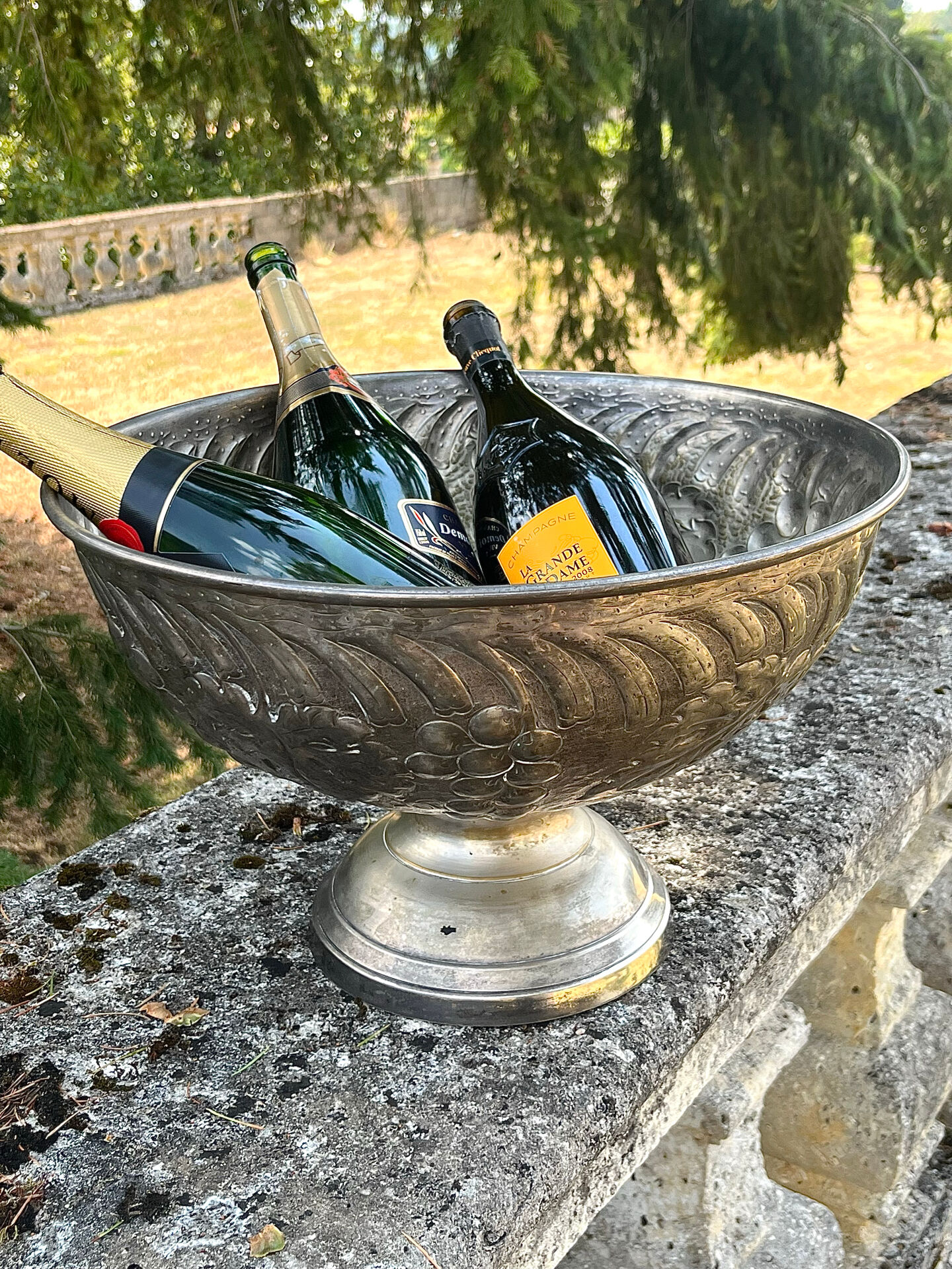 Large silver plated champagne cooler bowl on pedestal with grape