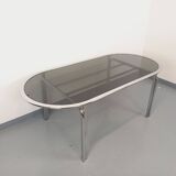 Vintage oval dining table in smoked glass and chrome metal, Space Age style.
