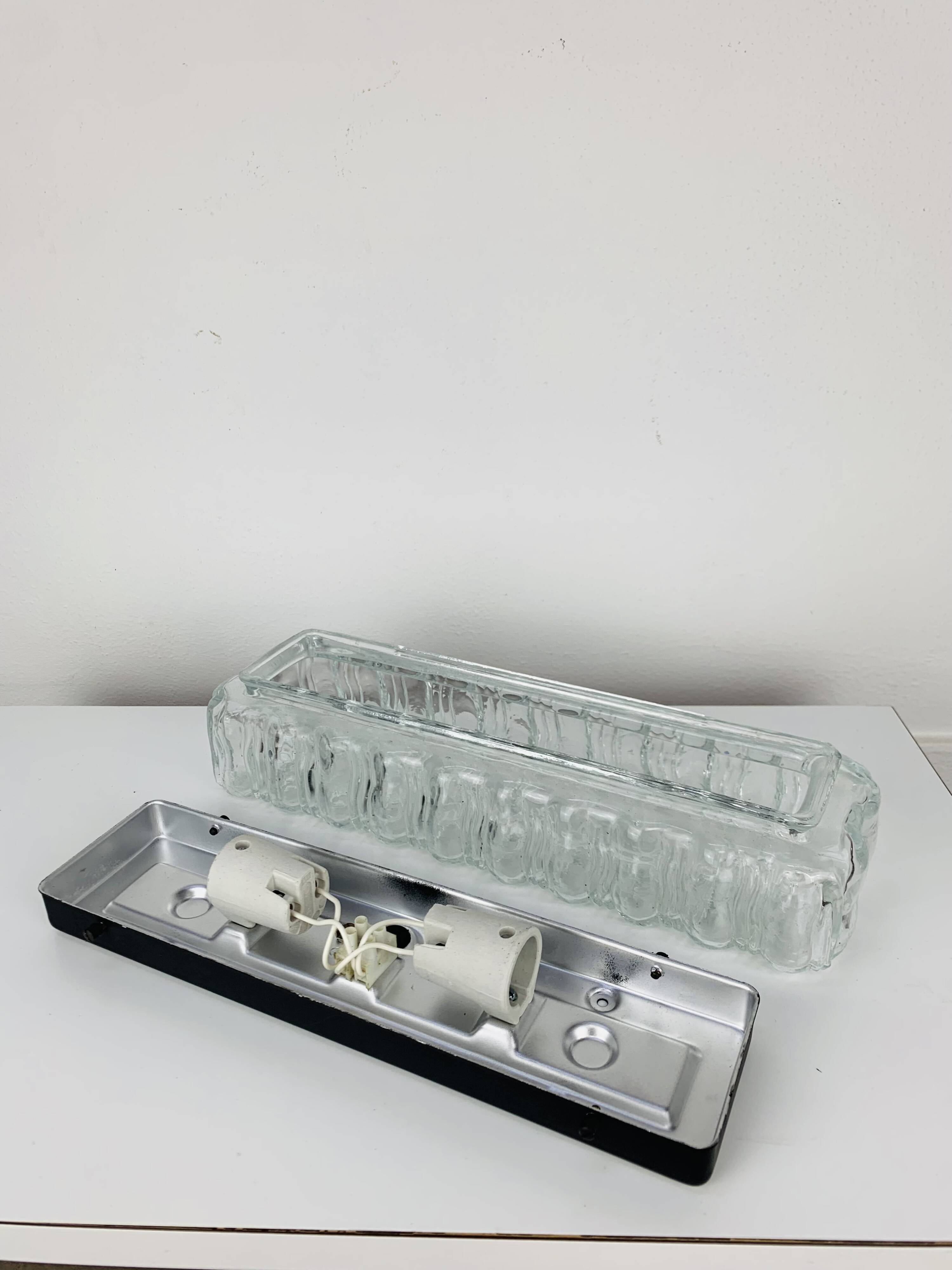 Rectangular wall lamp in molded glass and black metal from the 60s
