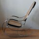 Rocking chair in chrome metal and wood