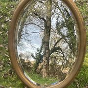 Bevelled golden oval mirror, 79 x 59 cm