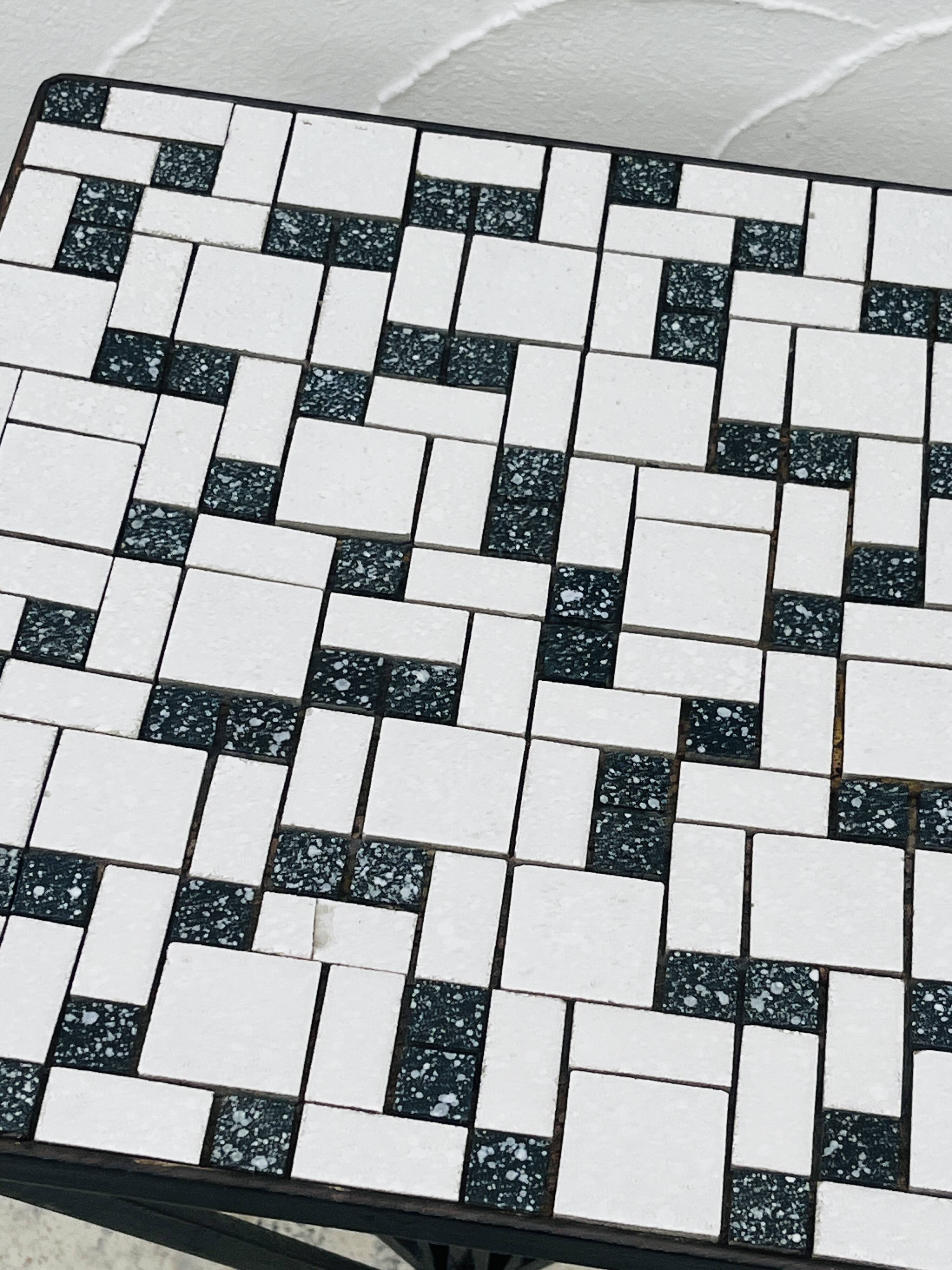 Wrought iron stela and black and white tiled top from the 1960s.