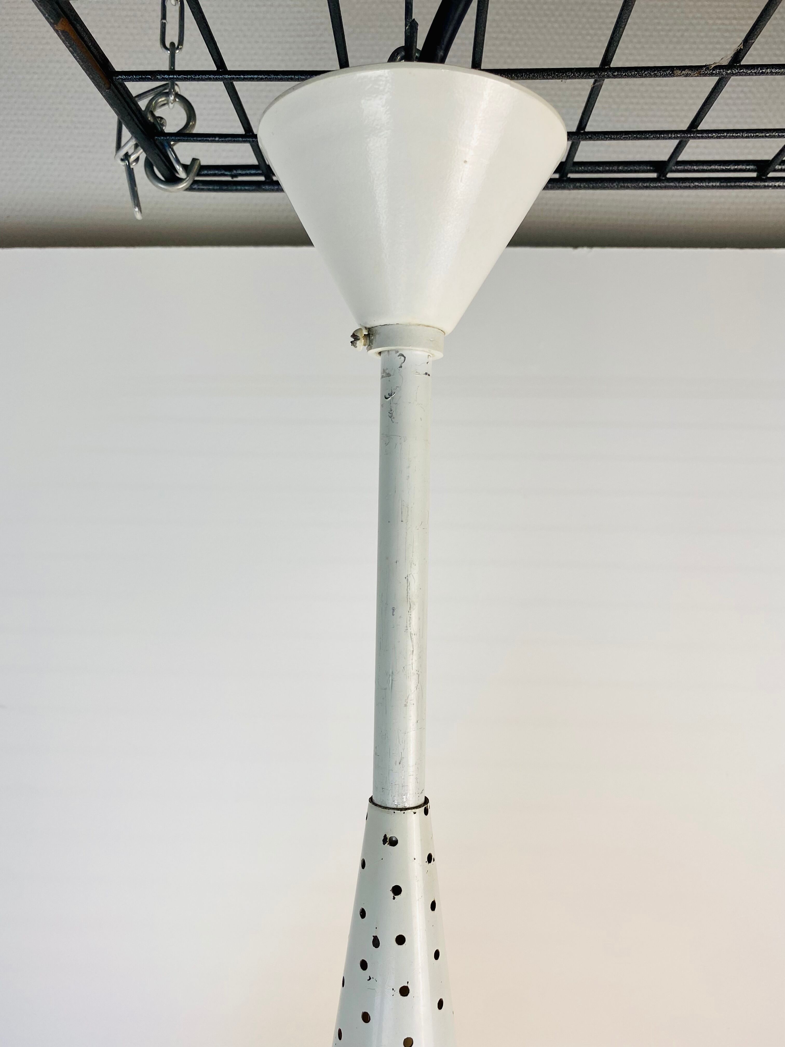 Perforated metal suspension holophanous glass