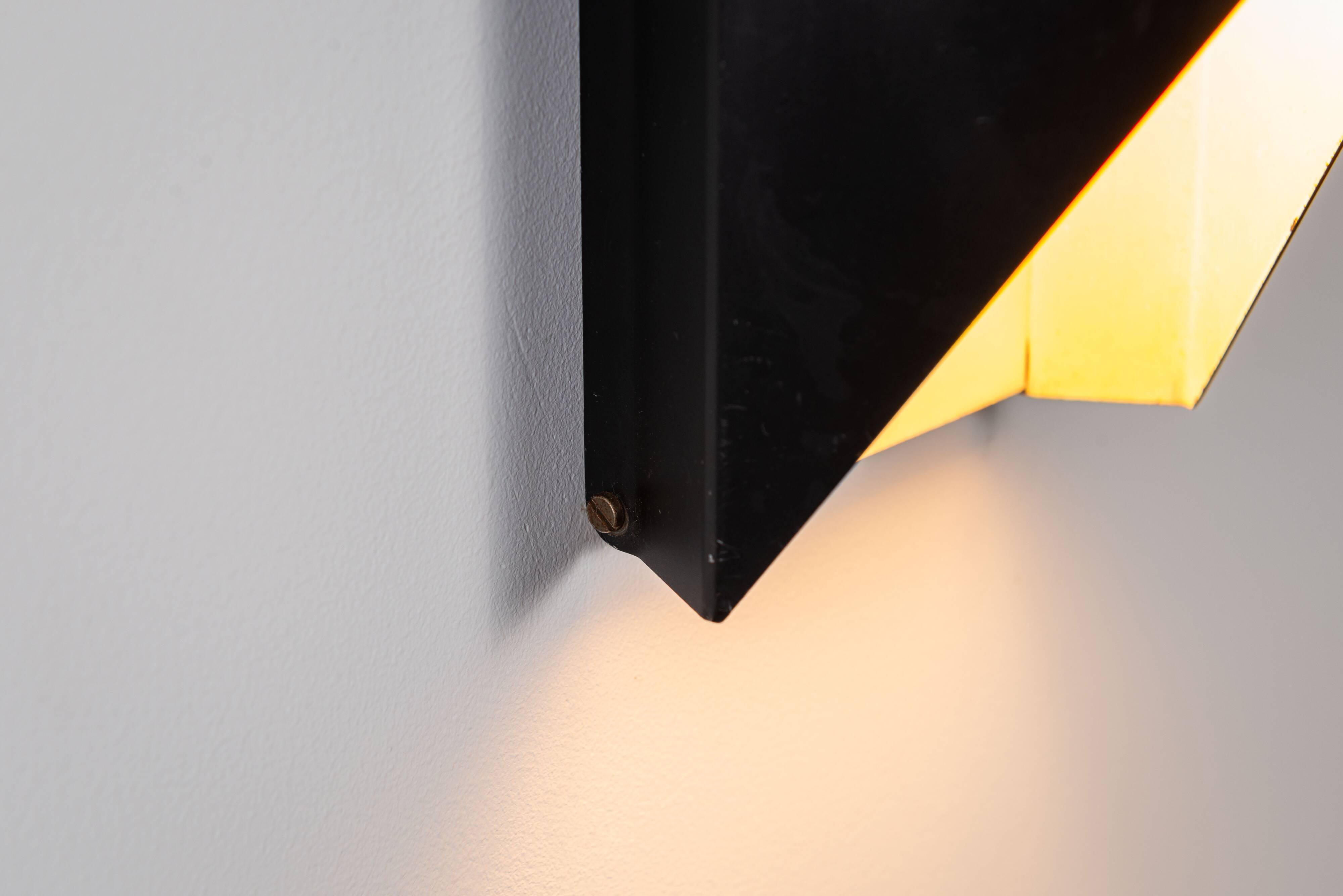 Architectural pair of vintage black metal wall lamps with angular geometric