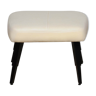 Upholstered pouf with black legs