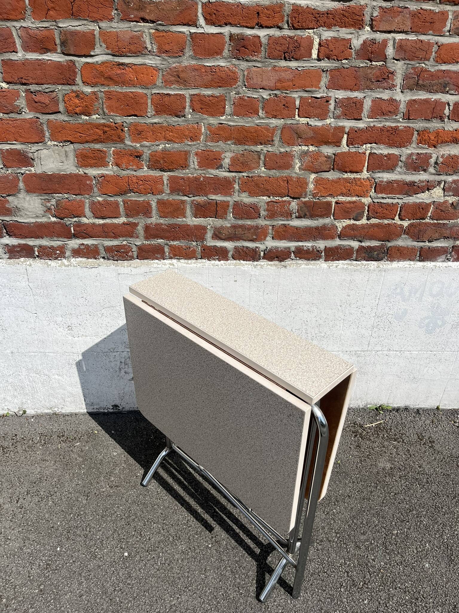 Folding table with chrome and pink formica.