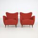 Pair of red armchairs with cone-shaped feet, 1950s