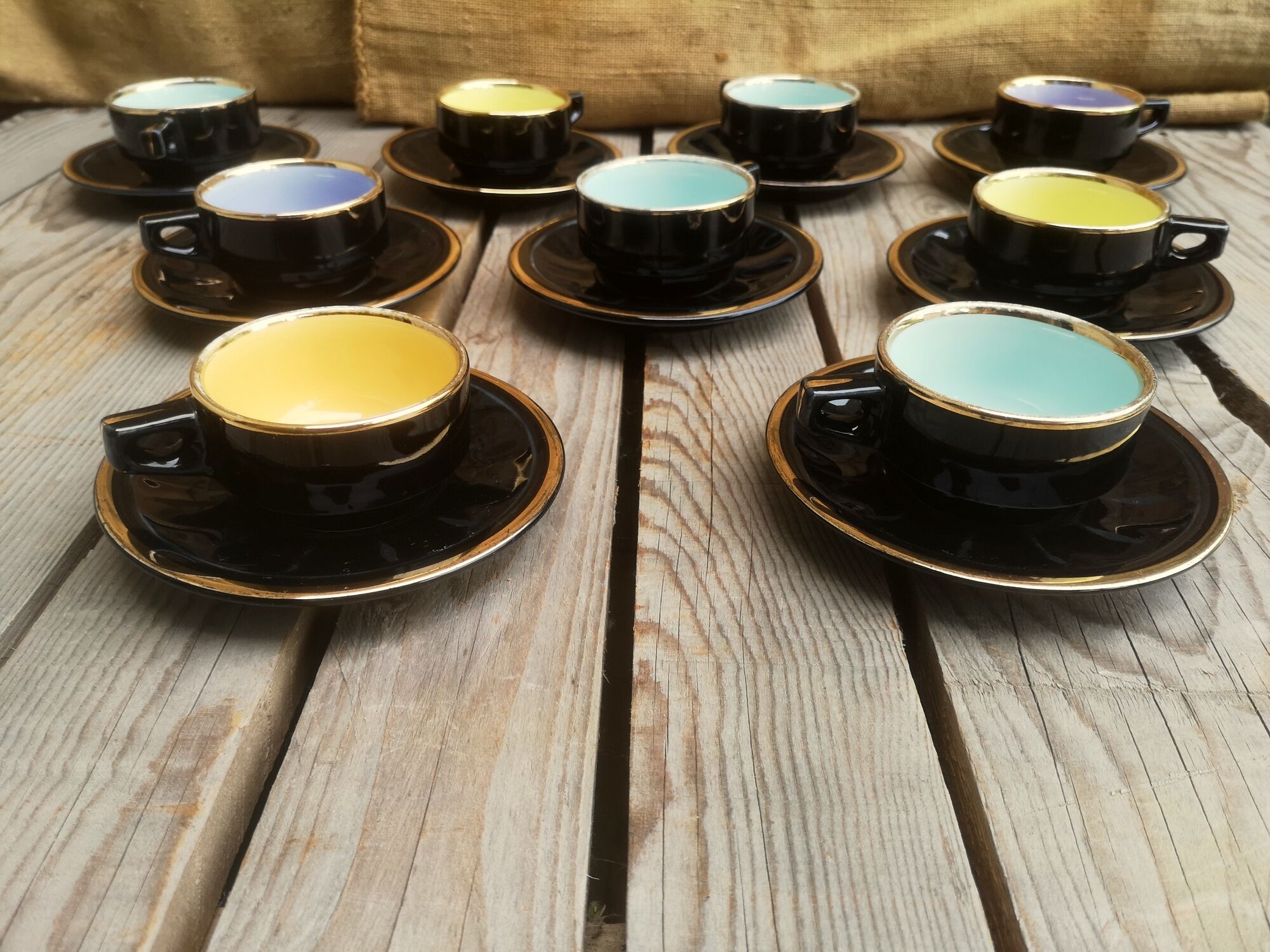 Set of 9 cups and sub-cups in black ceramic and colored gold border