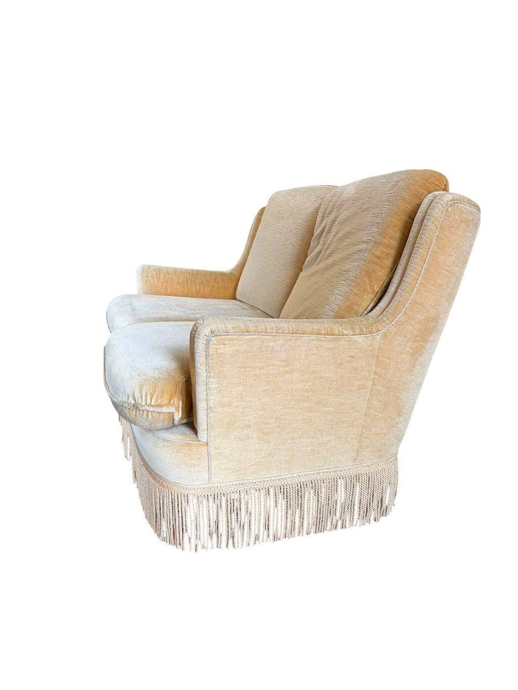 Vintage beige two-seater sofa with fringes