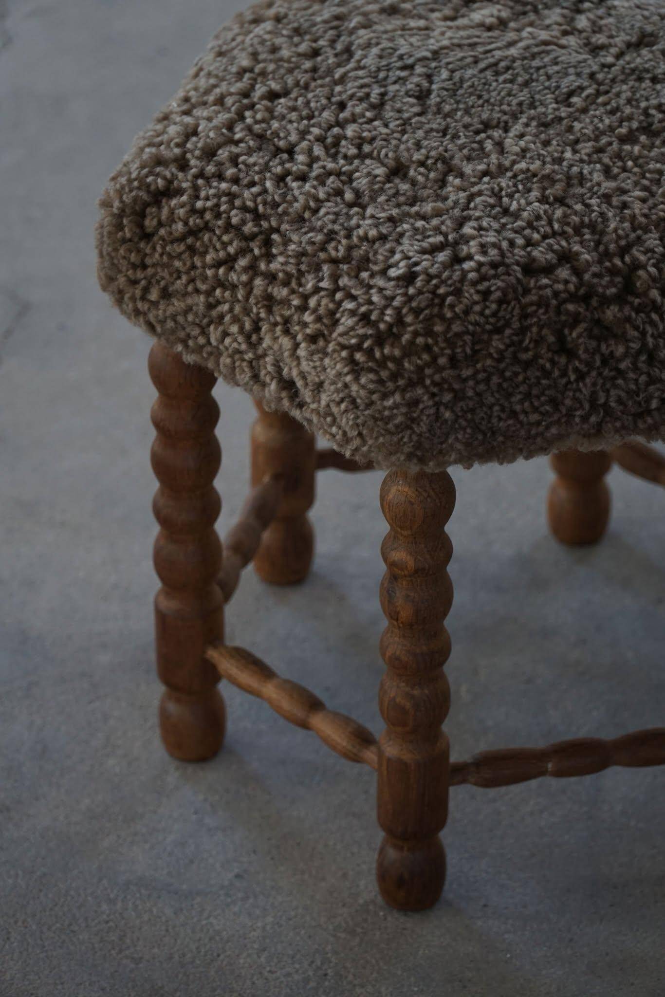 A hexagonal oak stool, seat refurbished in lambswool, Danish design from the 1950s.