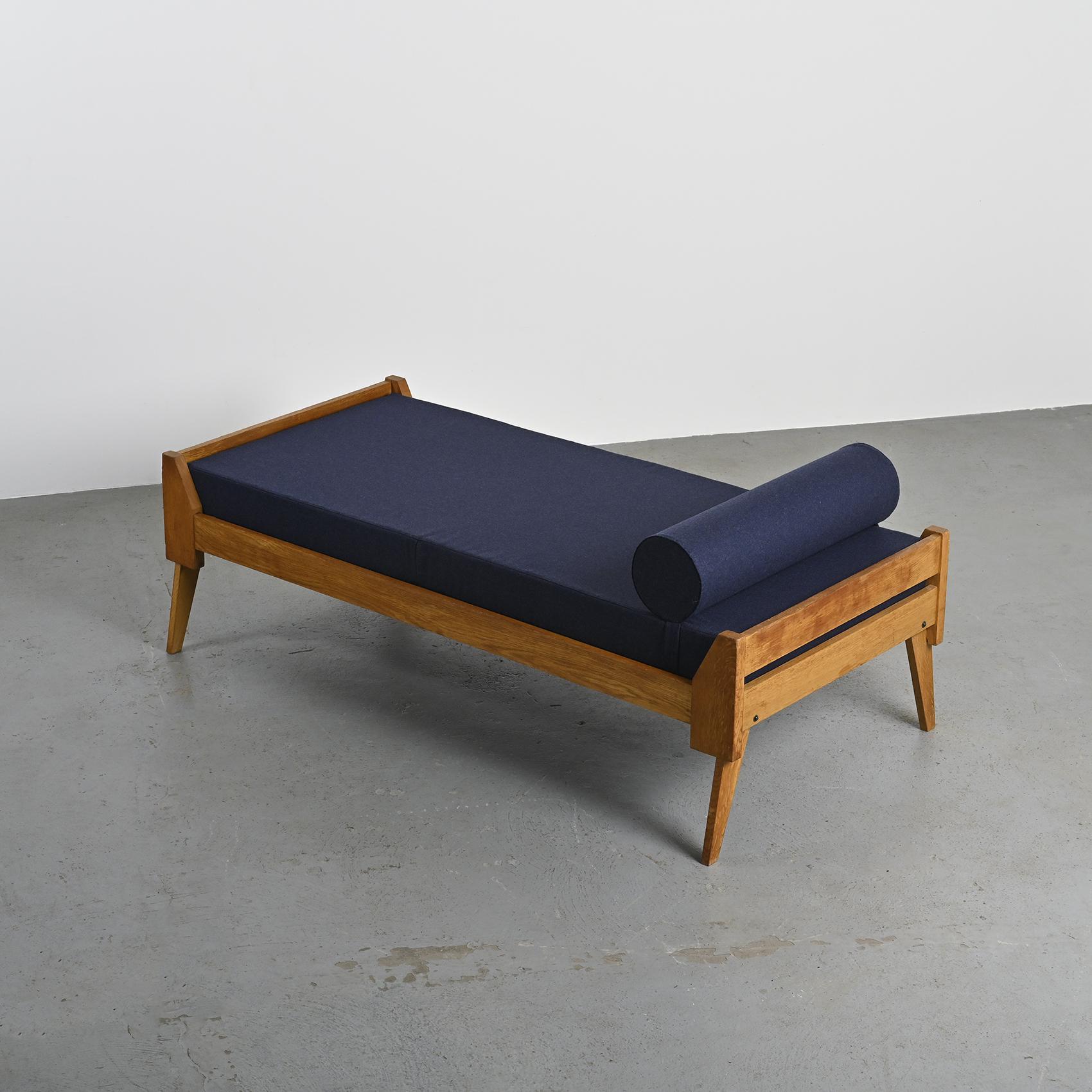 Wooden bench with midnight blue fabric, France, circa 1955