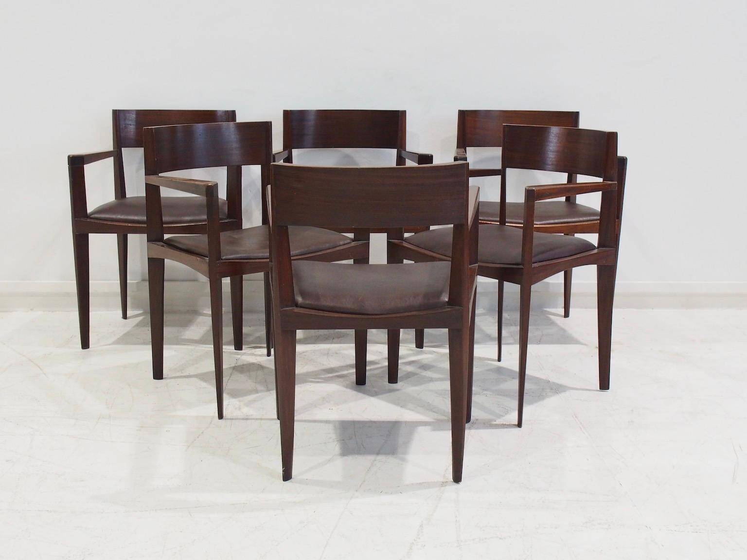 Set of six Italian wooden dining chairs in dark brown faux leather.