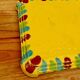 Yellow ceramic trivet and bottle coaster with vintage painted decoration.