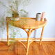 Half-moon rattan console