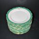Paris porcelain set of 12 flat plates with green border and gold monogram JC.