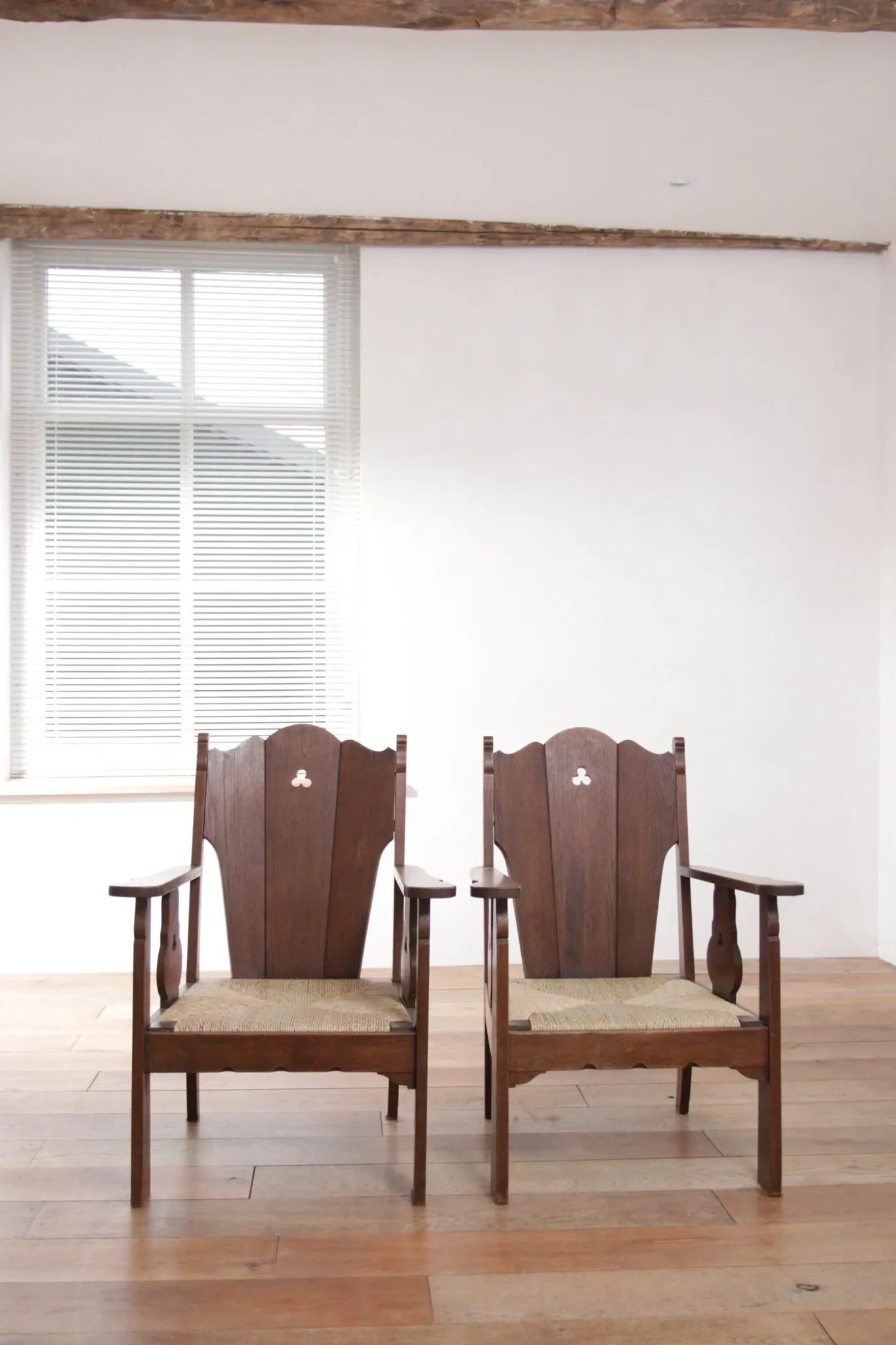 Pair of low Brutalist oak lounge chairs with new rush seats – circa 1935