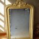 Napoleon mirror in gilded wood