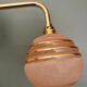 Vintage pink and gold frosted glass globe wall light.