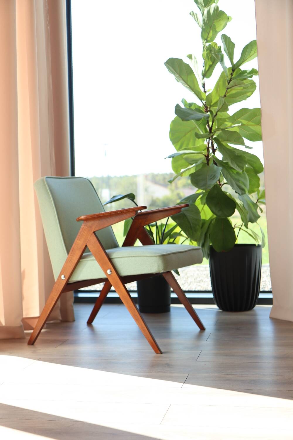 Vintage armchair in mint green wool, mid-century modern design.