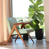 Vintage armchair in mint green wool, mid-century modern design.