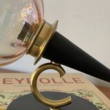 Pair of torch wall lights with iridescent pink glass shades and gold trim.