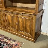 Library in walnut and oak from the early 20th century with its central clock.