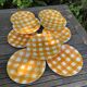 Set of nine flat ceramic plates yellow Scottish decoration in yellow/orange gridded ceramic