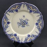 Old earthenware dish with a floral basket decoration.