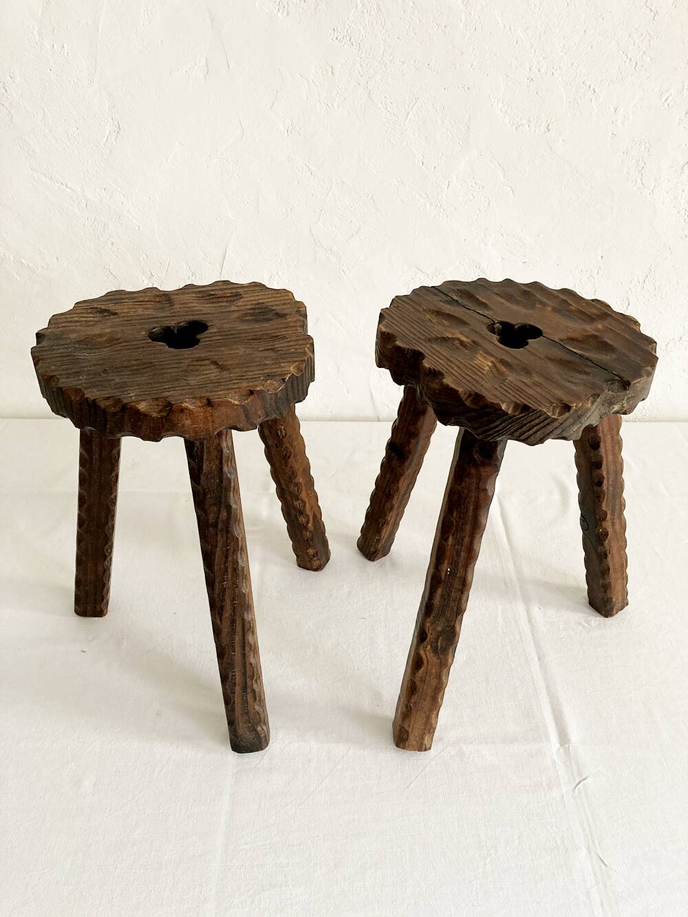 Pair of tripod farmhouse stools with clover pattern