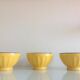 Suite of three yellow ribbed bowls with blue / vintage 70s border