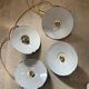 Vintage industrial enameled sheet metal pendant lights with golden wires, old green and white lampshade