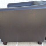 2 club armchairs with a chocolate faux leather seat and backrest and wooden legs.