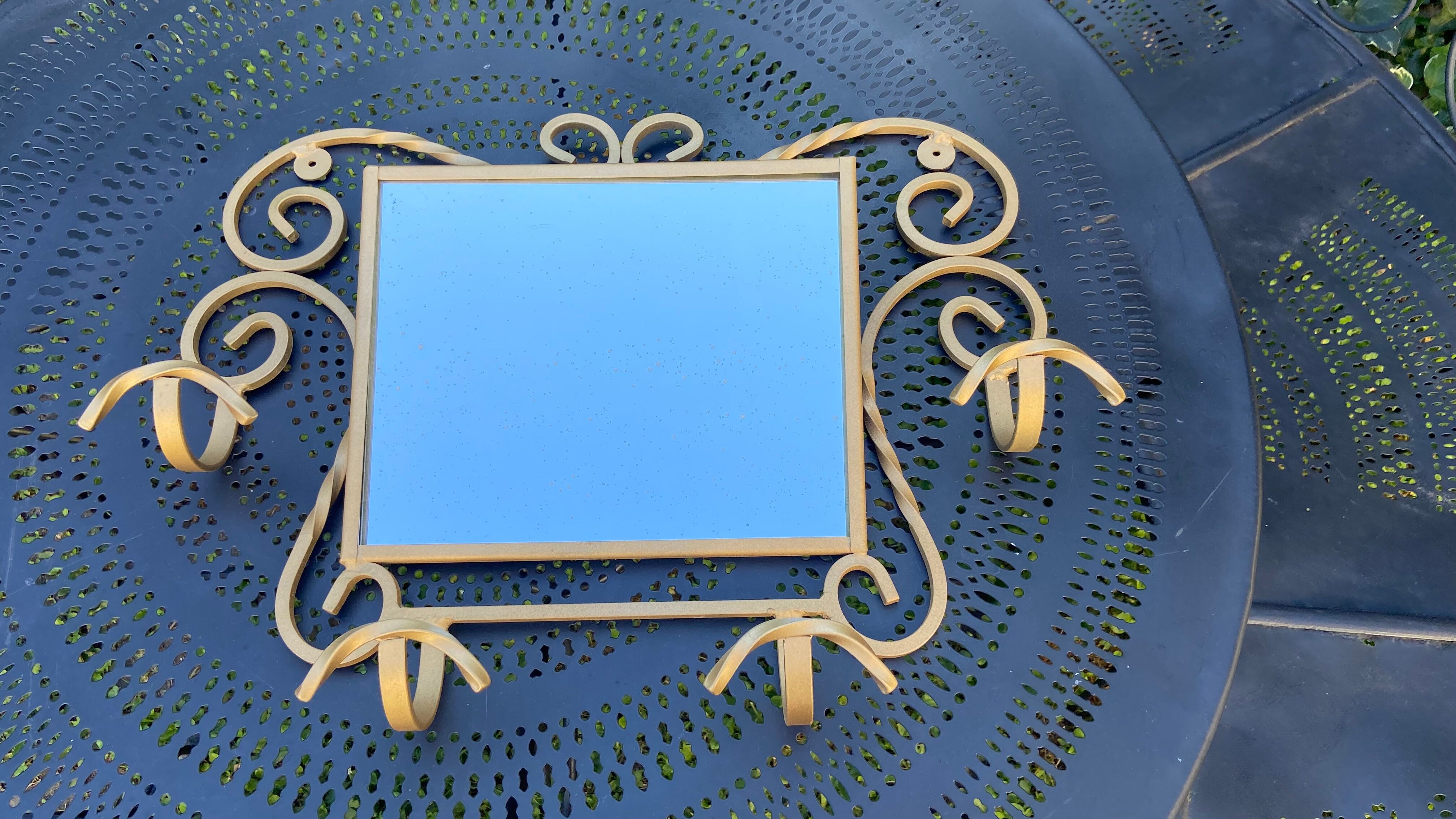 Wall-mounted gilded wrought iron coat rack with mirror