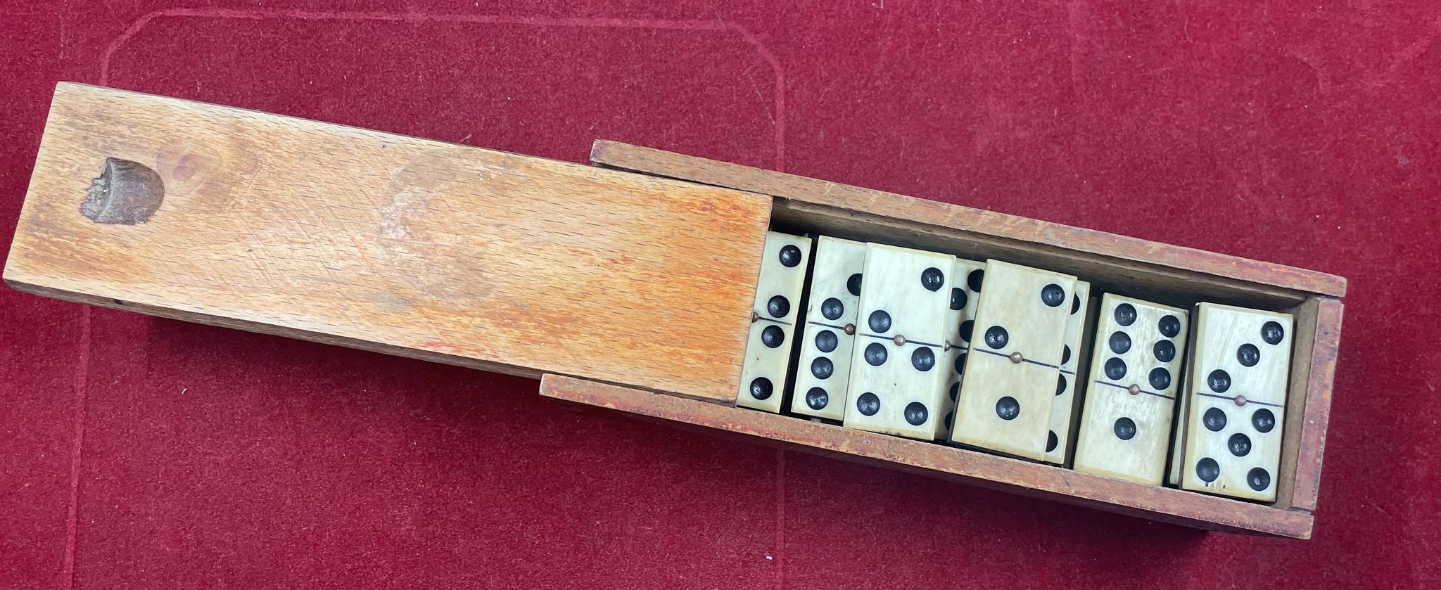 Set of complete dominoes made of bone, nails and blackened wood