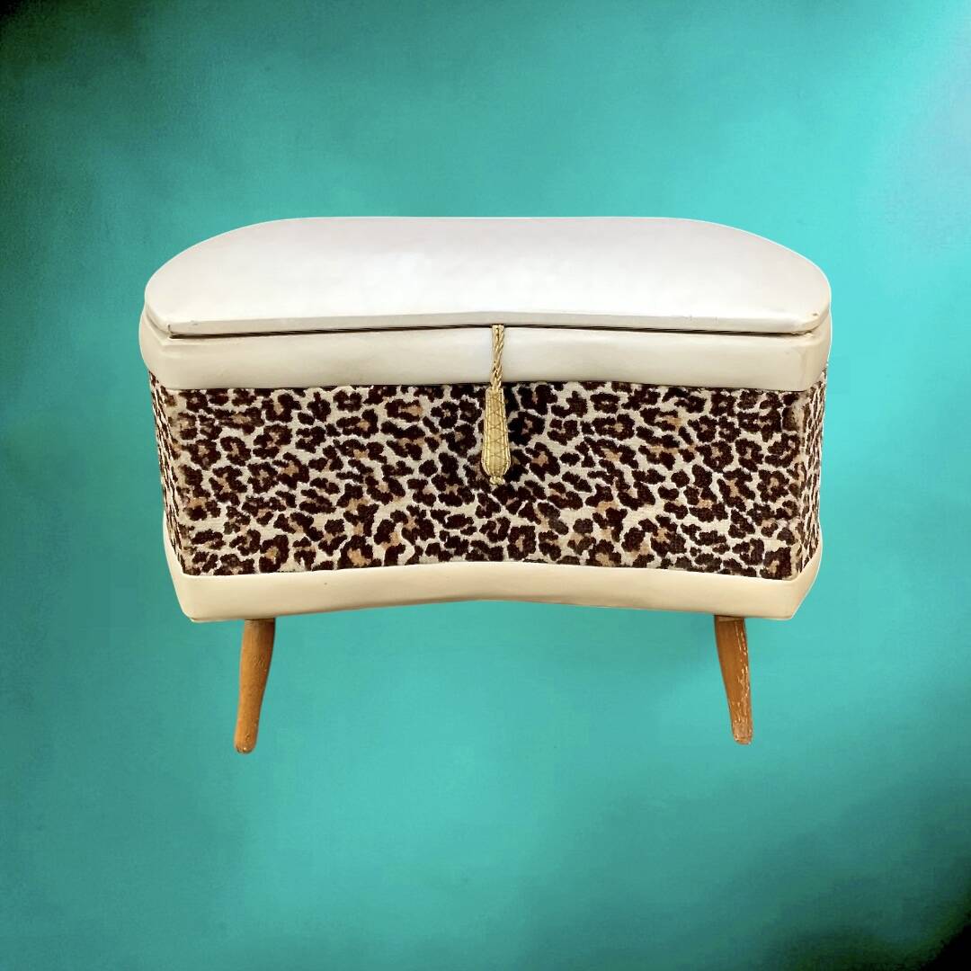 Vintage storage stool with compass legs in white faux leather and leopard velvet.