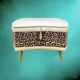 Vintage storage stool with compass legs in white faux leather and leopard velvet.