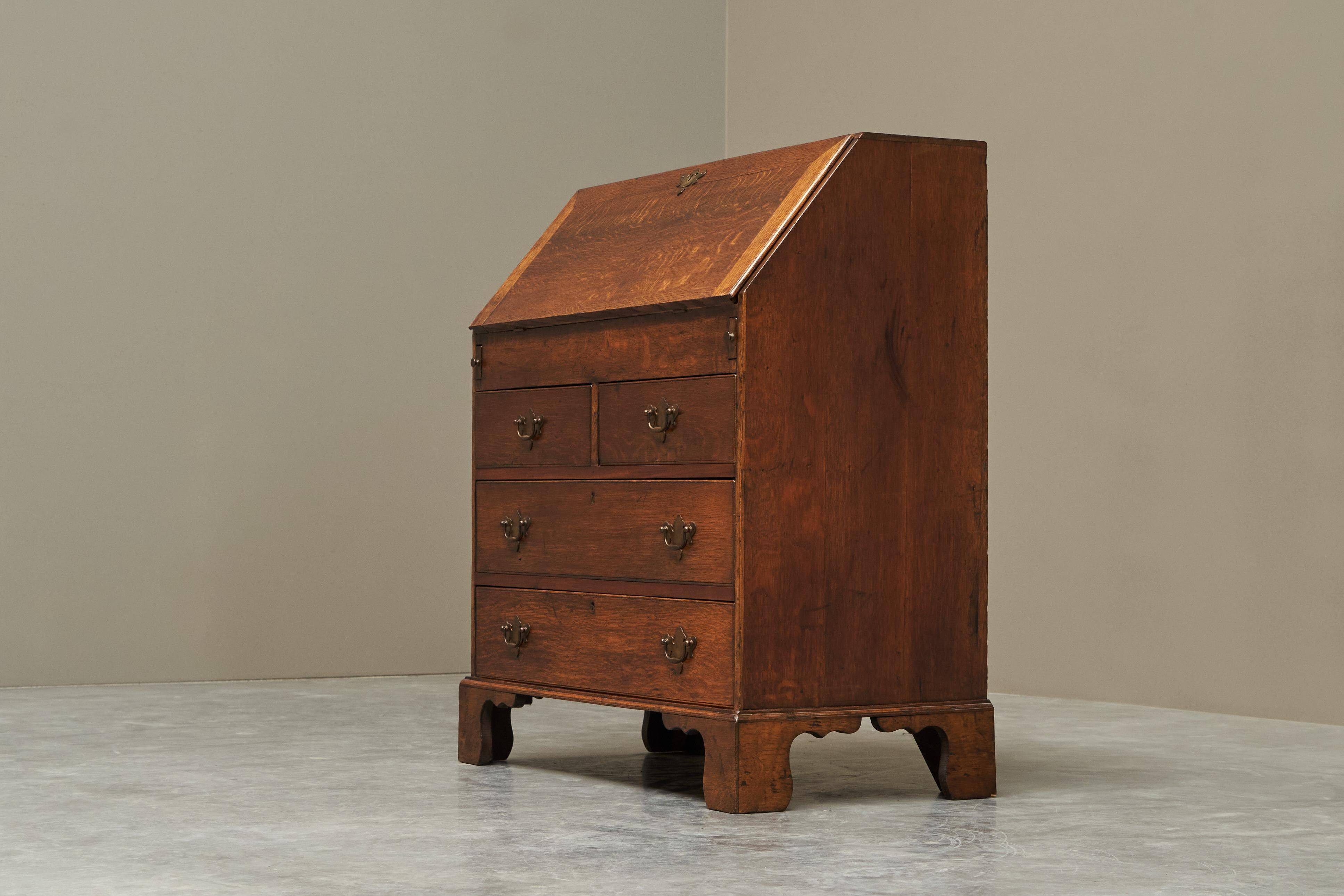 Antique English oak secretary with drop-down front.