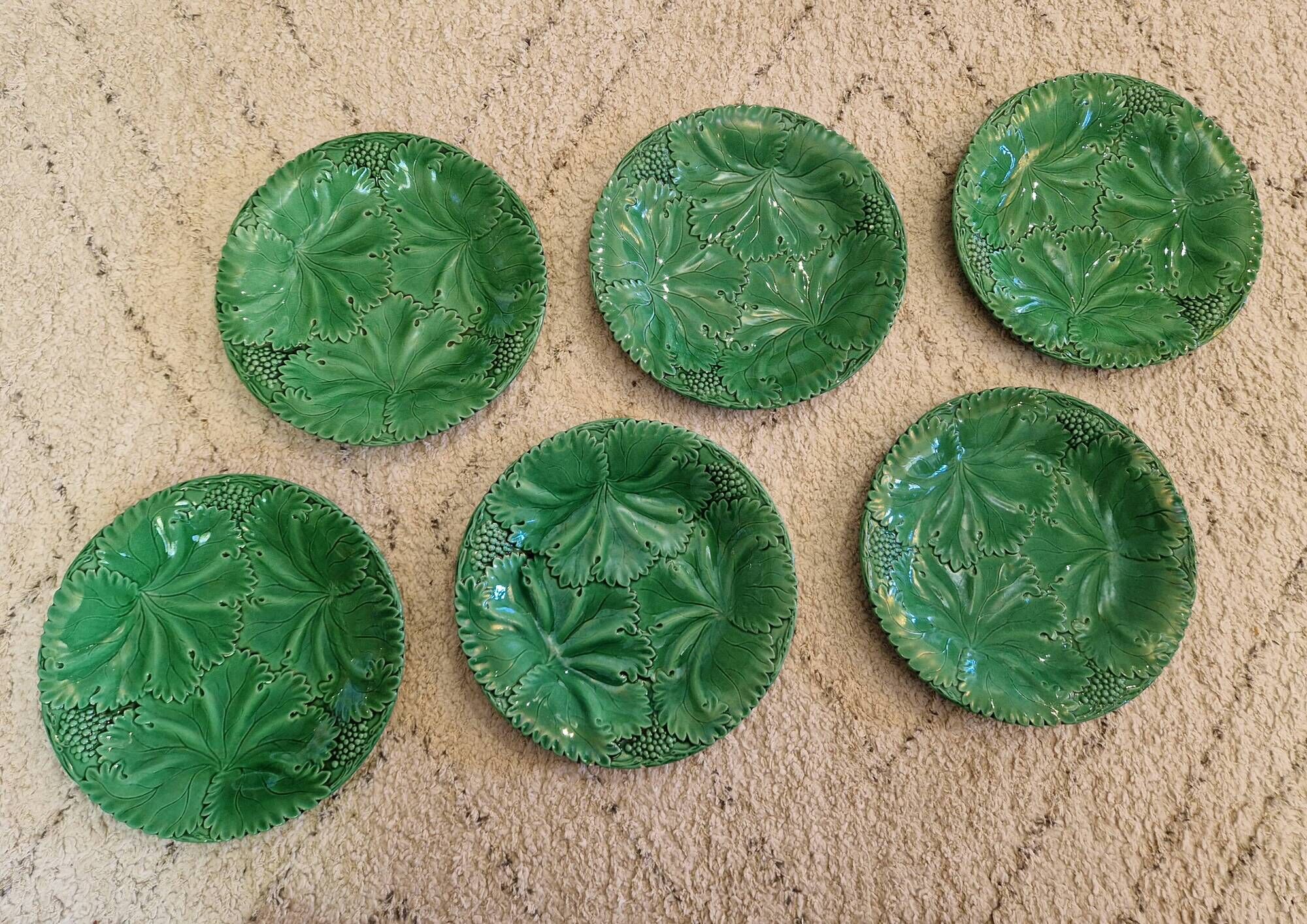 8 green barbotine plates from the early 20th century.