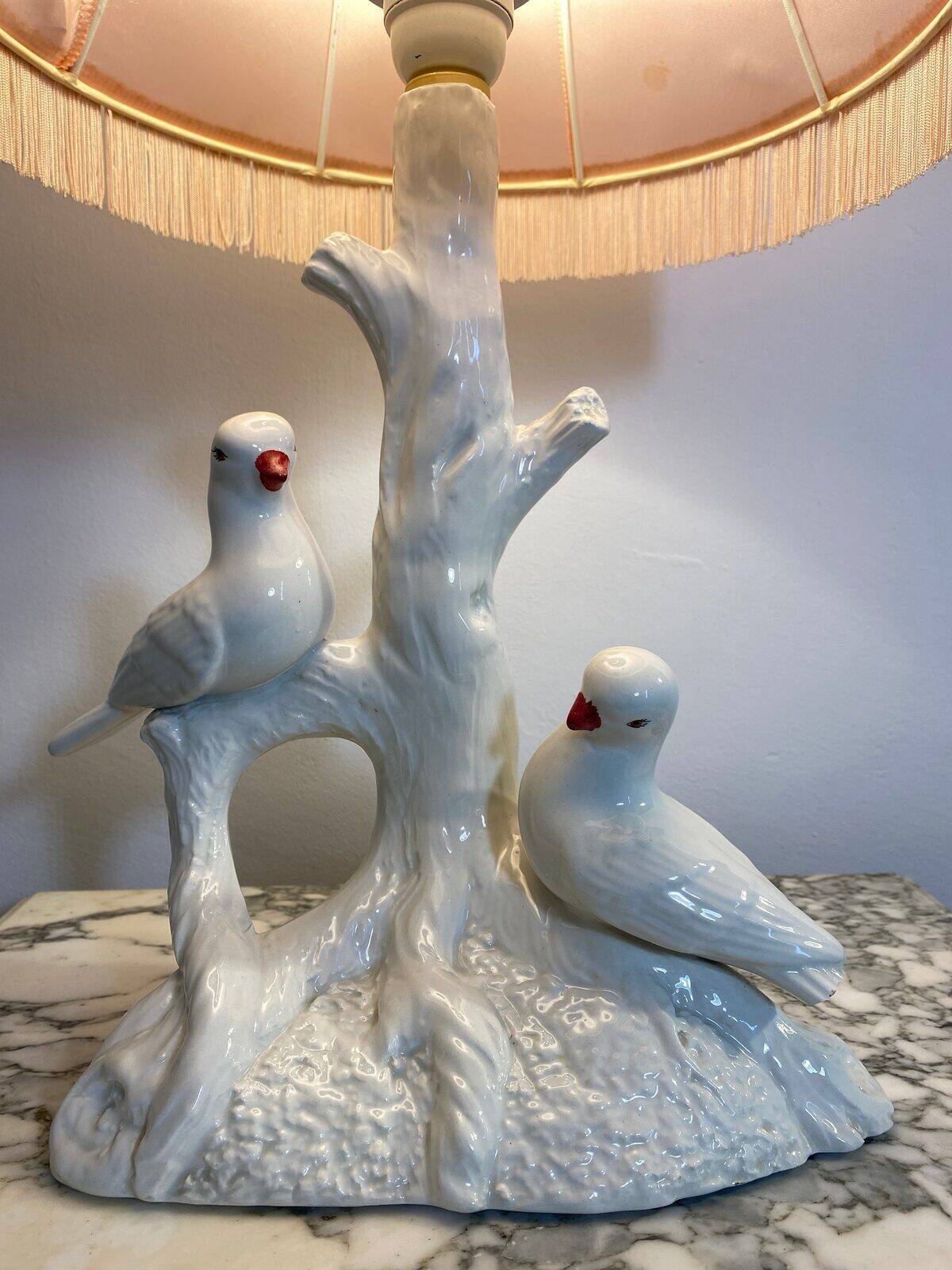 Ceramic lamp with birds, pink fringed shade, 1950s.