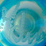 Blown blue glass bottle with inclusions