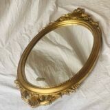 Old oval mirror in gilded resin - baroque style - 73 cm