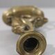 Handheld candlestick in bronze featuring a griffin, 19th-century Empire style.