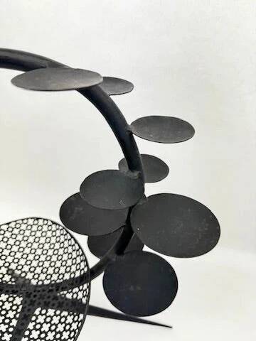 Candlestick sculpture in perforated iron clover motif