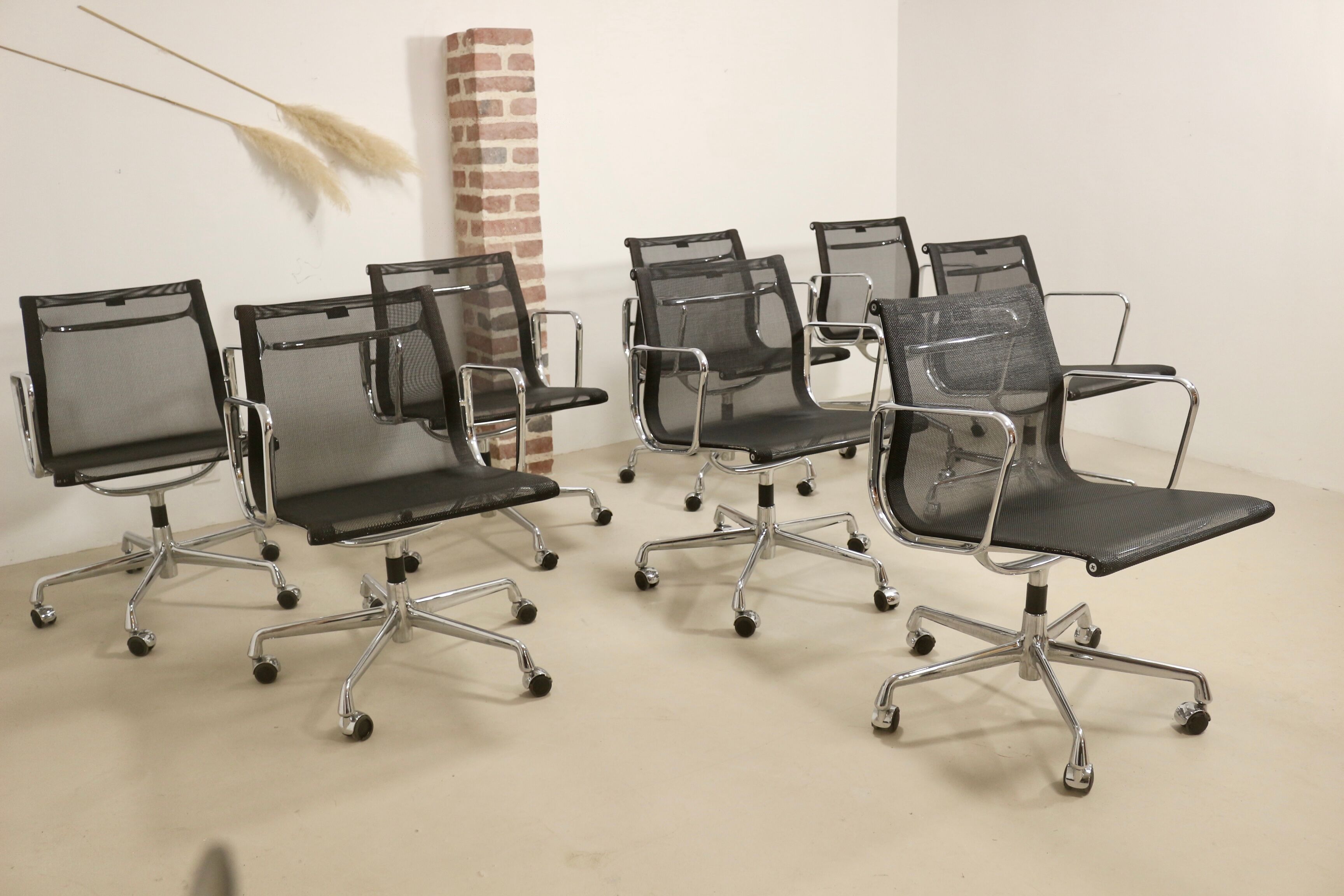 Set of 8 Charles and Ray Eames armchairs by Vitra model EA 117