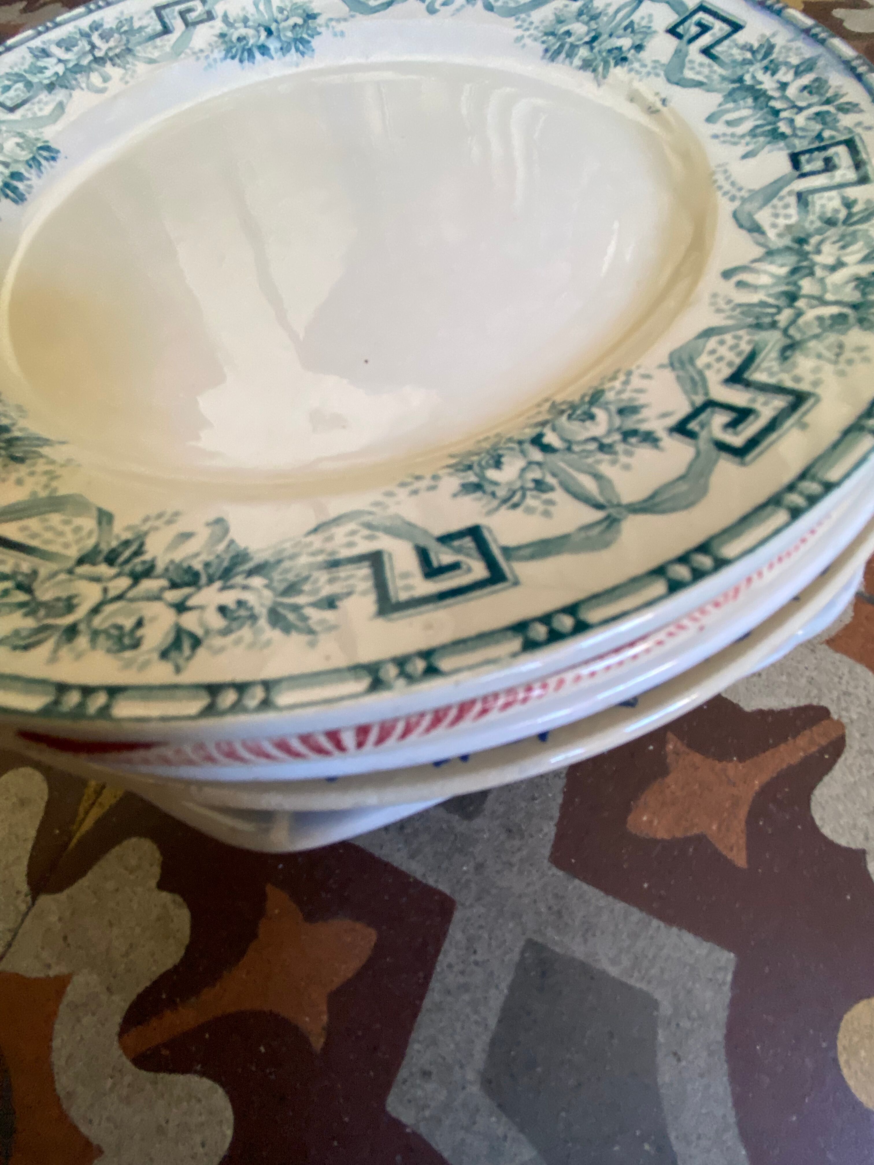 7 matching dessert plates in red green and blue.